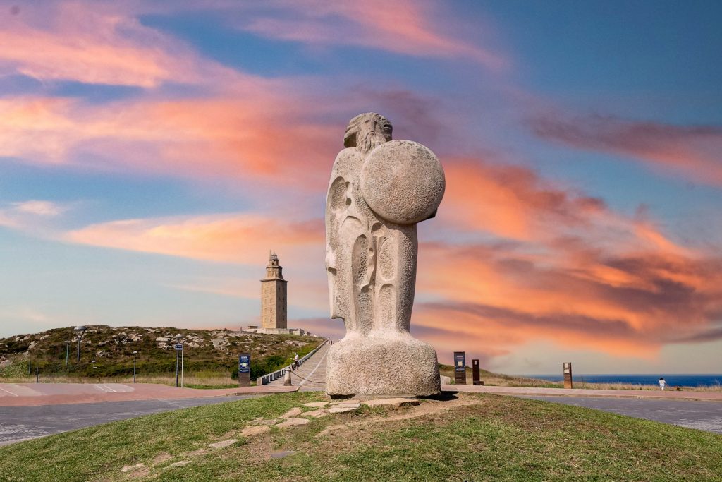 gray concrete statue under cloudy sky during daytime